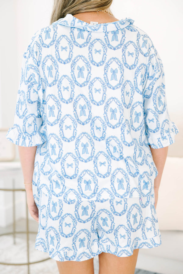 Plus Size blue and white bow print pajama set with a tie-front top and matching ruffled shorts.