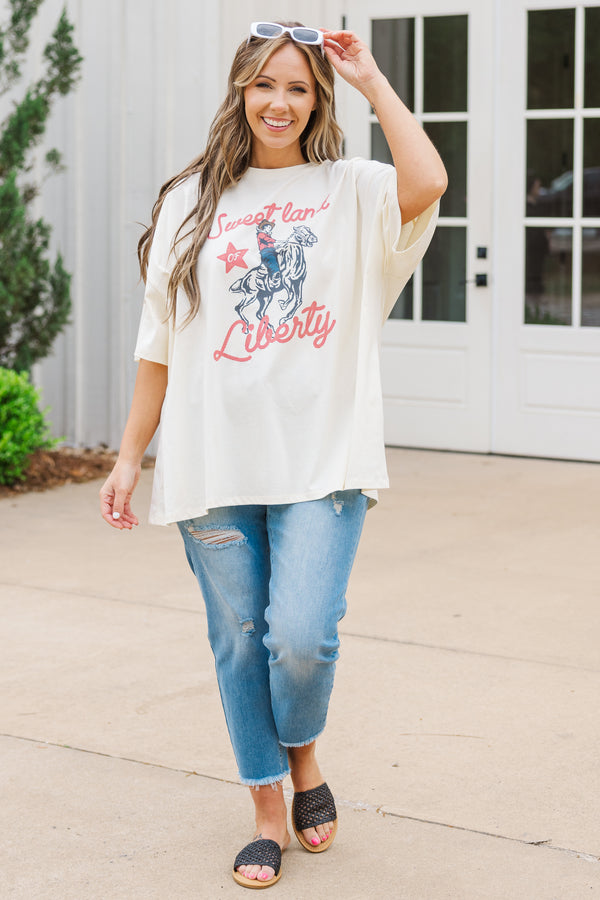 Plus Size ivory oversized boyfriend tee with a Sweet Land of Liberty horse graphic and blue jeans.