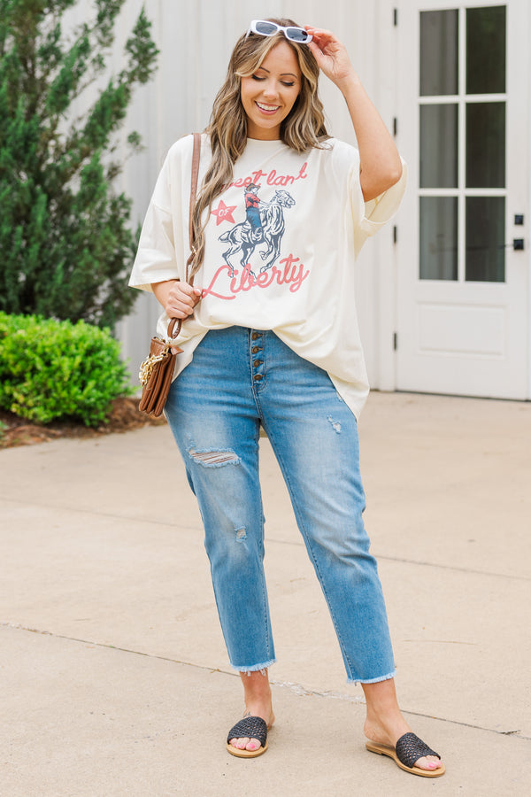 Plus Size ivory oversized boyfriend tee with a Sweet Land of Liberty horse graphic and blue jeans.
