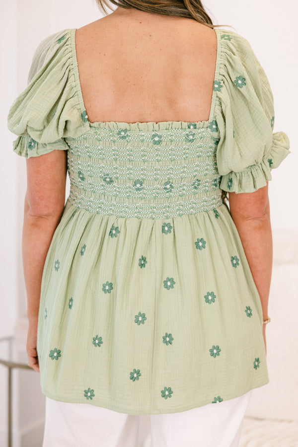 Chic Soul plus size clothing, short-sleeve ruffled puffed flowy pale sage green baby doll top with a square-neckline and a smocked bodice with a darker green subtle floral pattern 