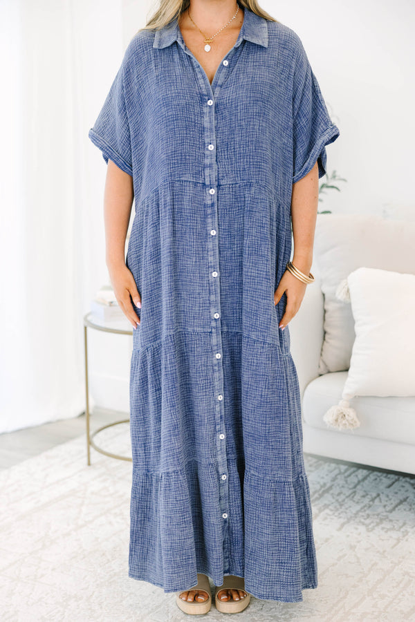 Plus size navy blue, flowy tiered maxi dress with a button-down front and short sleeves.