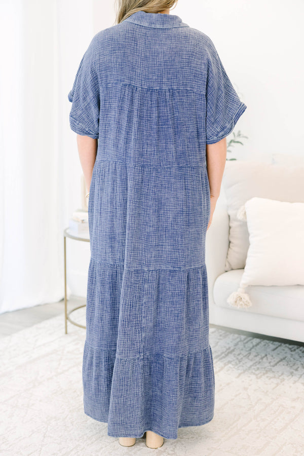 Plus size navy blue, flowy tiered maxi dress with a button-down front and short sleeves.