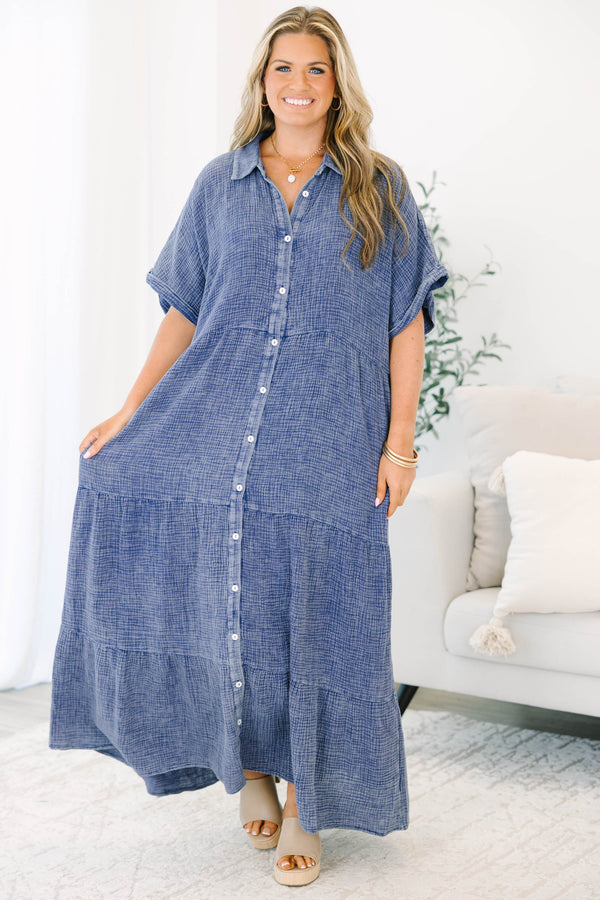 Plus size navy blue, flowy tiered maxi dress with a button-down front and short sleeves.