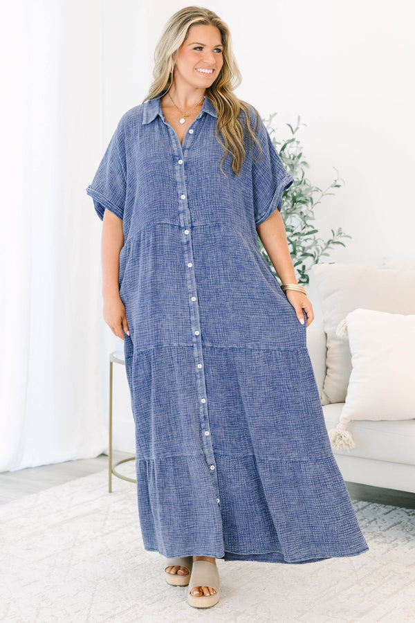 Plus size navy blue, flowy tiered maxi dress with a button-down front and short sleeves.