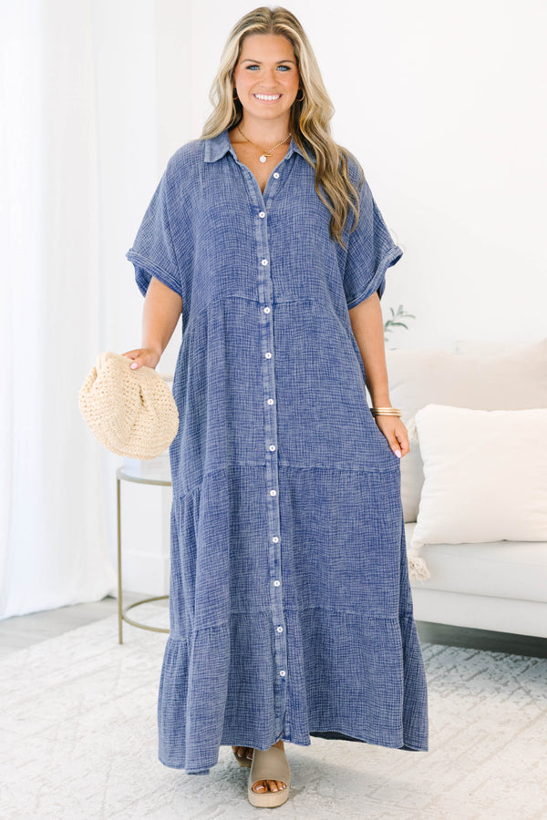 Plus size navy blue, flowy tiered maxi dress with a button-down front and short sleeves.