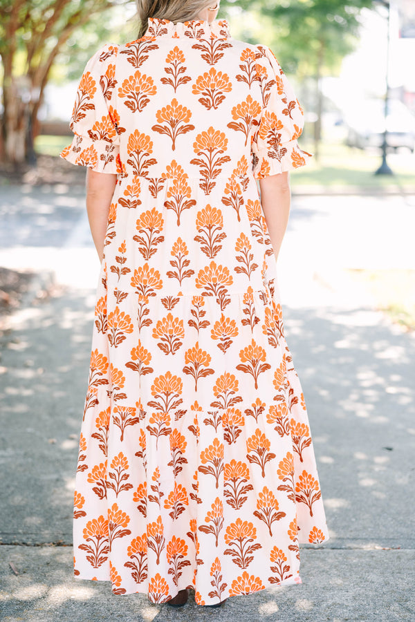 Plus Size orange floral tiered maxi dress with puff sleeves and a brown button-down neckline.