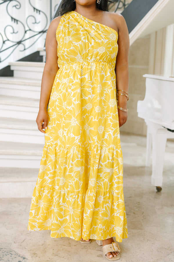 Plus Size yellow one-shoulder maxi dress with a white floral print and tiered skirt.