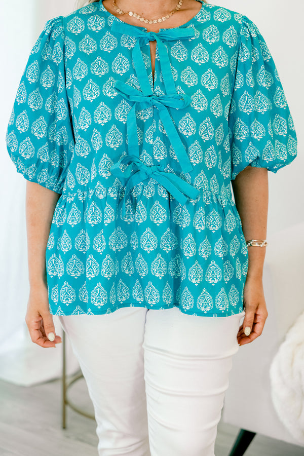 Chic Soul Plus size clothing, bright blue top with bubble sleeves a block pattern and the bows going down the center of the shirt 