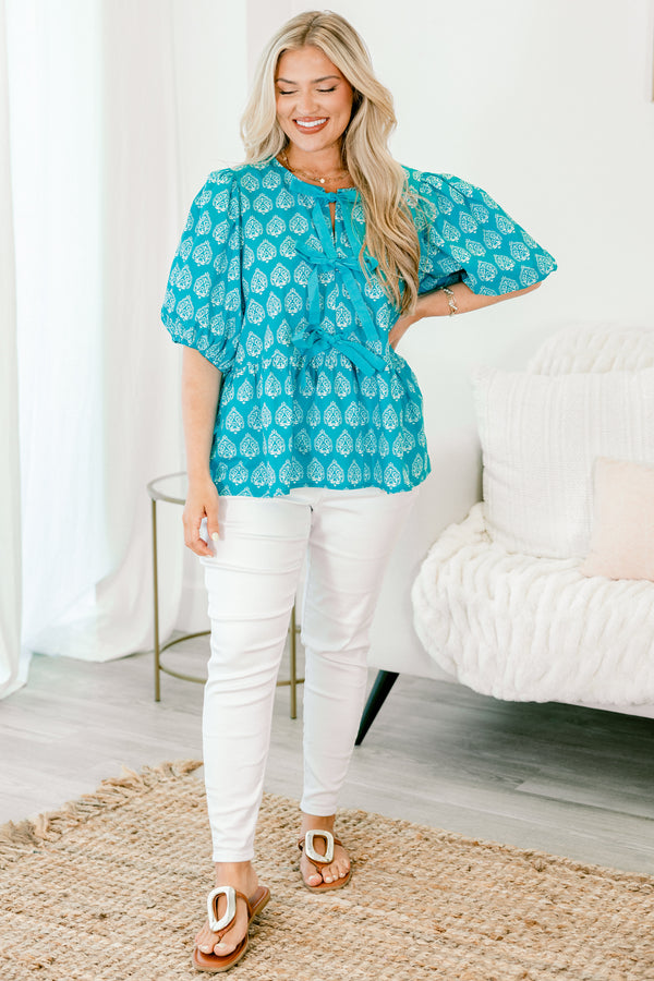 Chic Soul Plus size clothing, bright blue top with bubble sleeves a block pattern and the bows going down the center of the shirt 