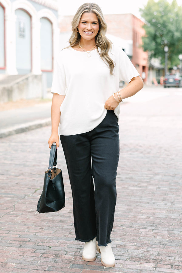 Plus Size black acid-washed wide-leg jeans with a frayed cutoff hem and a straight fit.