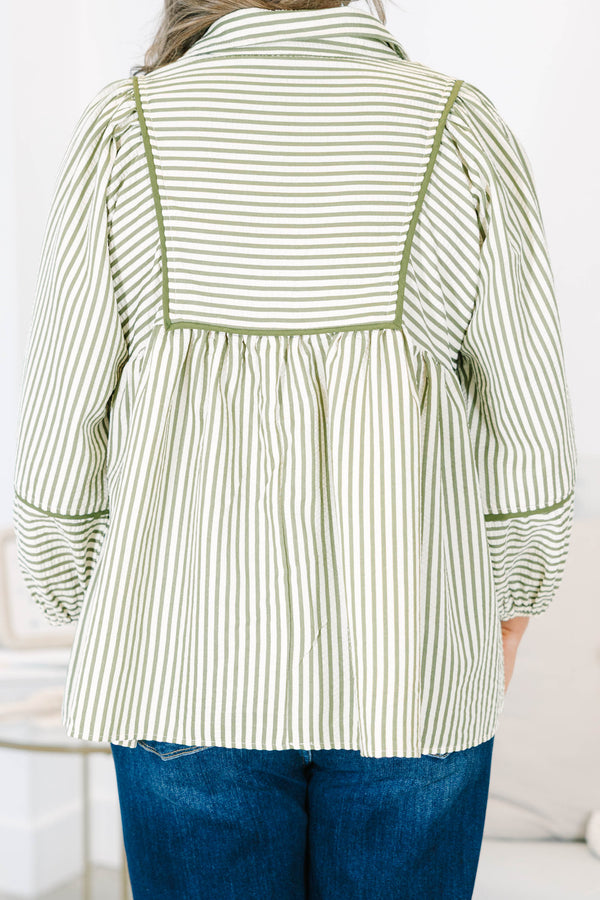 Plus size olive and white striped flowy top with long puff sleeves and a v-neckline.
