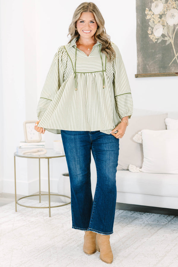 Plus size olive and white striped flowy top with long puff sleeves and a v-neckline.