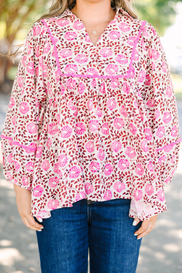 Plus size pink floral print top with a flowy fit, V-neckline, and long balloon sleeves.