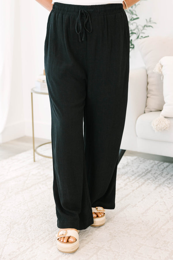 Plus Size black wide-leg pants with an elastic drawstring waistband and a textured fabric.