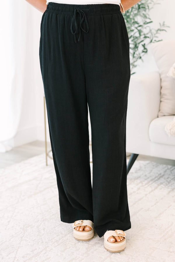 Plus Size black wide-leg pants with an elastic drawstring waistband and a textured fabric.