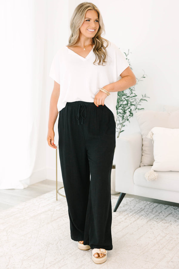 Plus Size black wide-leg pants with an elastic drawstring waistband and a textured fabric.