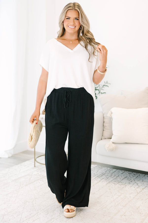 Plus Size black wide-leg pants with an elastic drawstring waistband and a textured fabric.