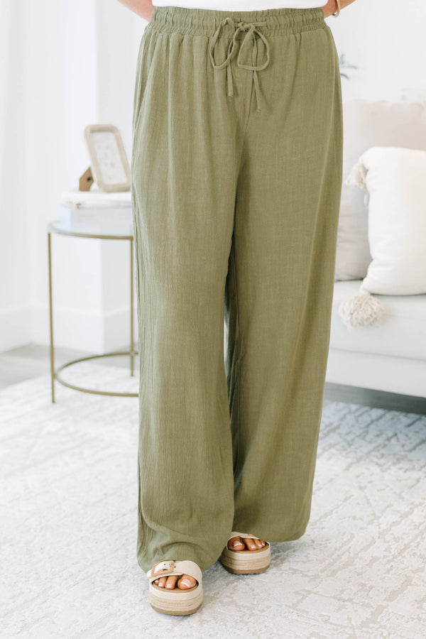 Plus Size olive green wide-leg pants with a drawstring elastic waistband and textured fabric.
