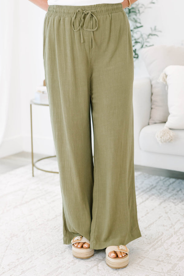 Plus Size olive green wide-leg pants with a drawstring elastic waistband and textured fabric.