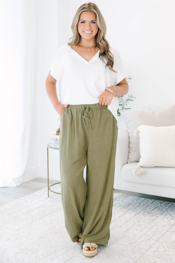 Plus Size olive green wide-leg pants with a drawstring elastic waistband and textured fabric.