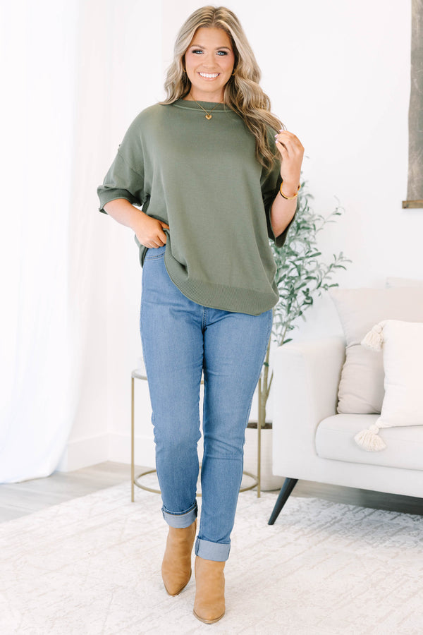 Plus size high-rise skinny jeans in denim blue with cuffed ankles and stretchy fabric.
