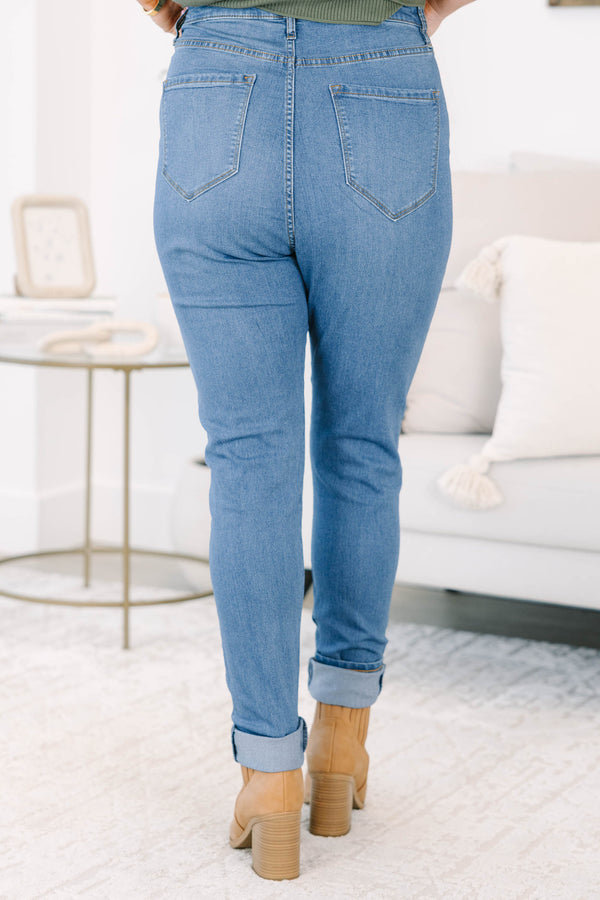 Plus size high-rise skinny jeans in denim blue with cuffed ankles and stretchy fabric.