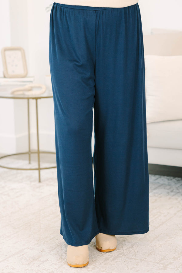 Plus size navy flowy palazzo pants with a high-rise elastic waistband in a soft ribbed fabric.