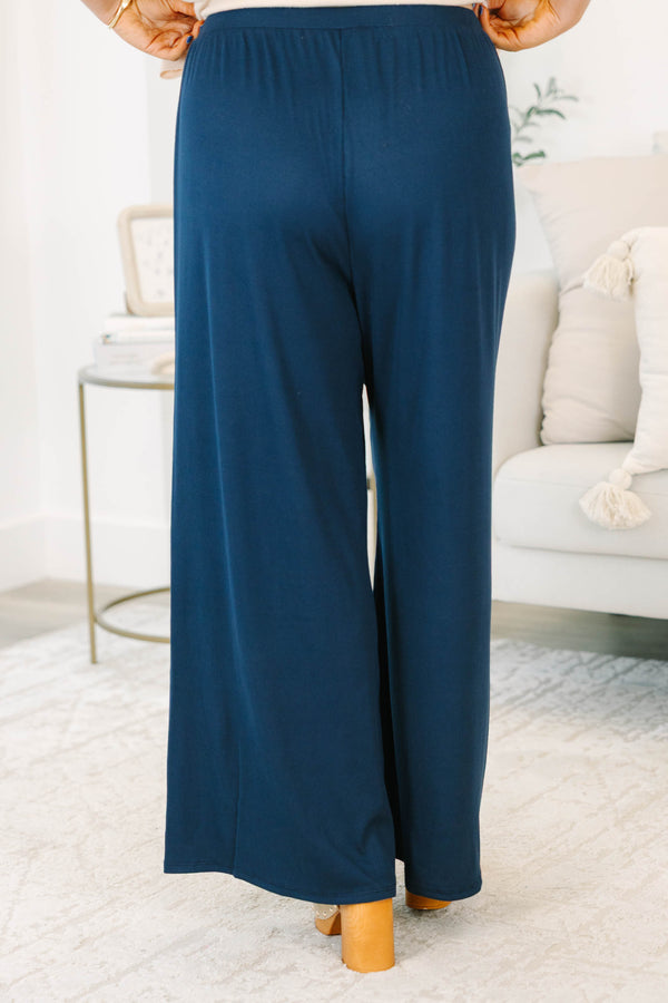 Plus size navy flowy palazzo pants with a high-rise elastic waistband in a soft ribbed fabric.