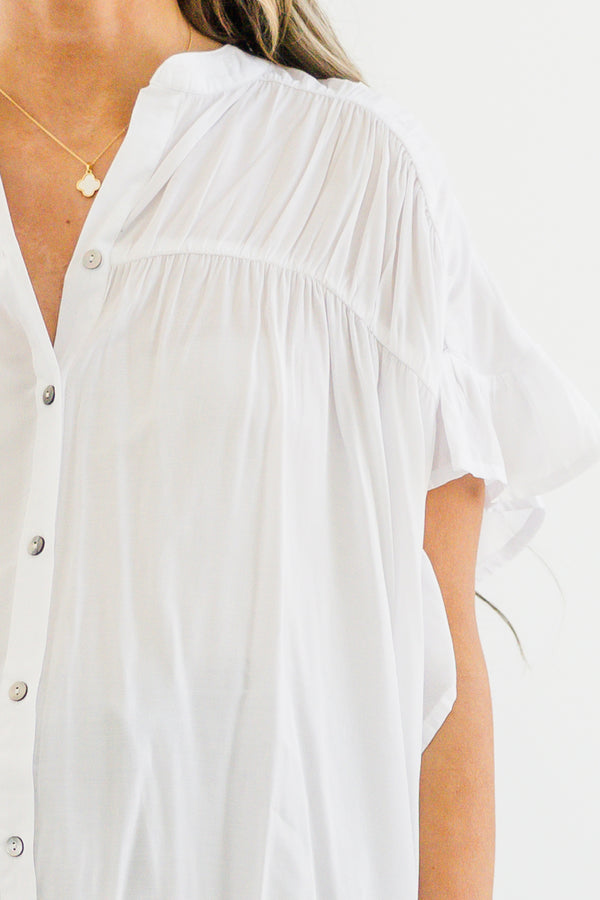 Chic Soul plus size clothing, short-sleeve ruffled white top with a buttoned v-neckline with silver button detailing