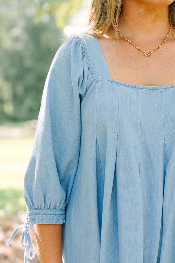 Plus Size light blue denim-look dress with a square neckline, pleated bodice, and puff sleeves.