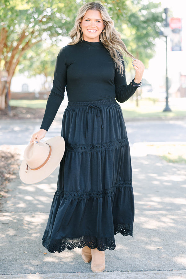 Plus size black tiered maxi skirt with lace trim, smocked waist, and flowy silhouette.
