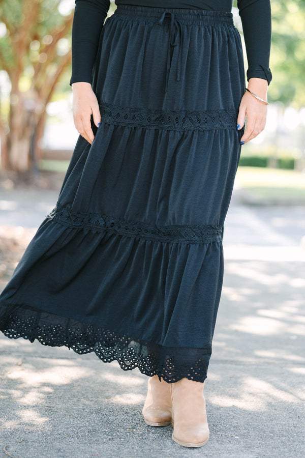 Plus size black tiered maxi skirt with lace trim, smocked waist, and flowy silhouette.