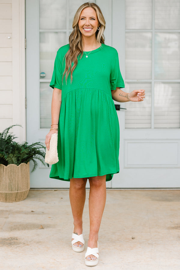 Plus Size emerald green short sleeve baby doll dress with a crew neckline and tiered skirt.
