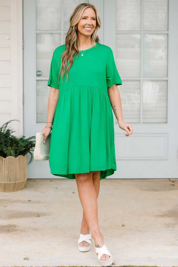 Plus Size emerald green short sleeve baby doll dress with a crew neckline and tiered skirt.