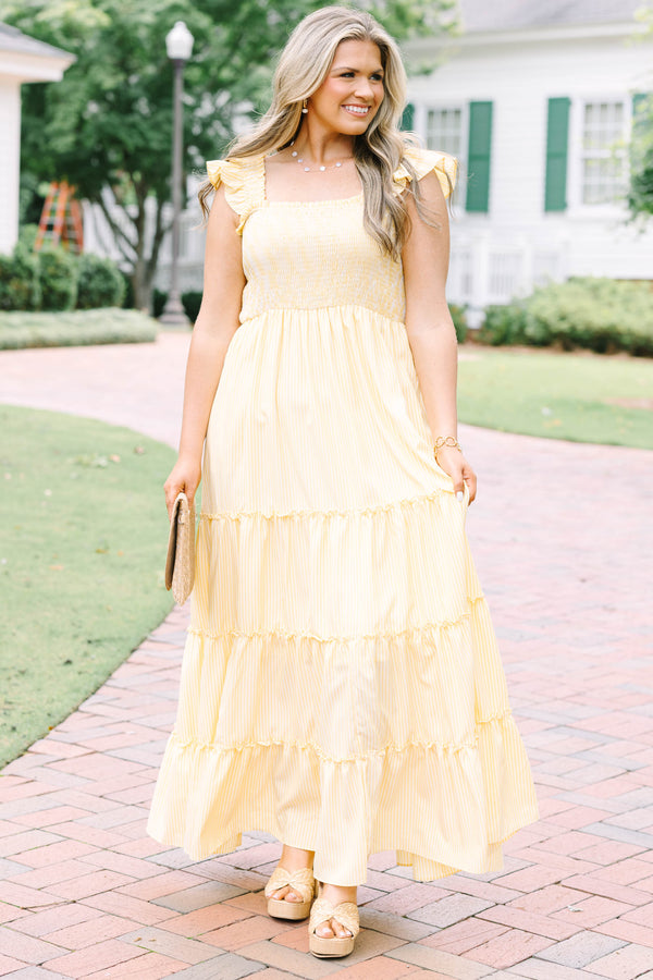 Plus Size yellow striped maxi dress with a smocked bodice, ruffled straps, and a tiered skirt.