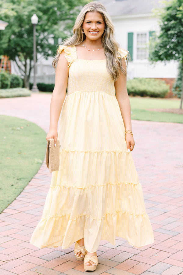Plus Size yellow striped maxi dress with a smocked bodice, ruffled straps, and a tiered skirt.
