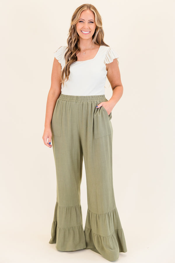Chic Soul plus size clothing, dusty olive green wide leg flared pants with elastic waistband with ruffled detailing on flare and side pockets