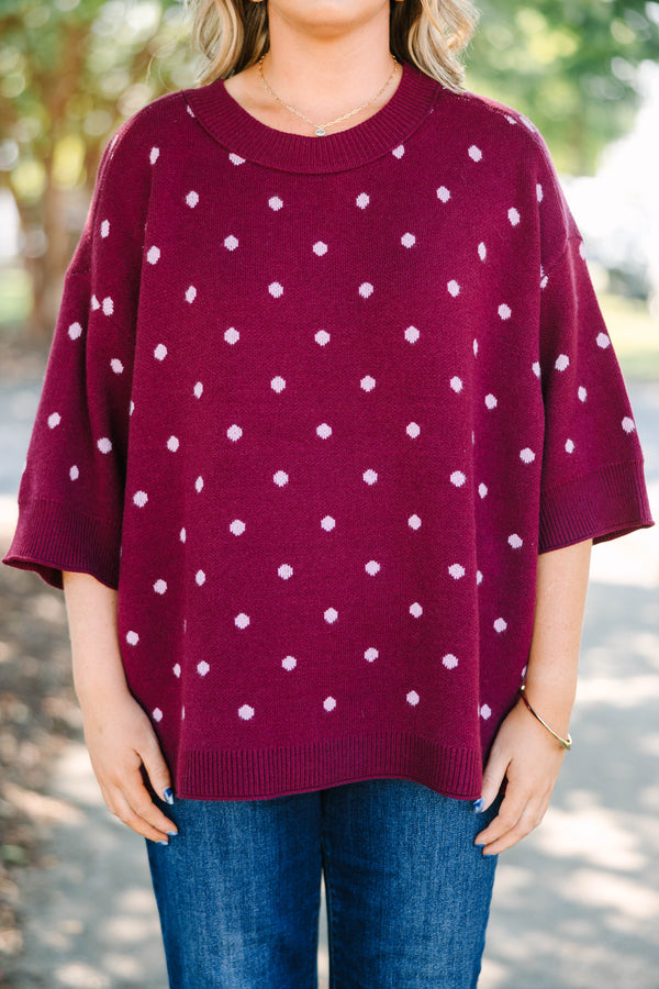 Plus size burgundy polka dot sweater with a relaxed fit, crew neck, and soft knit fabric.