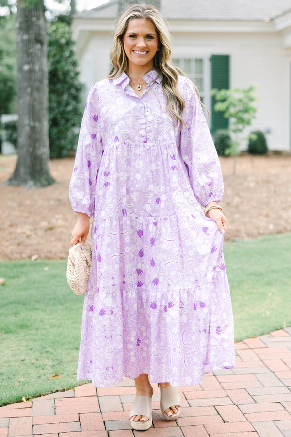 Plus size flowy lilac floral tiered maxi dress with long sleeves and a collared neckline.