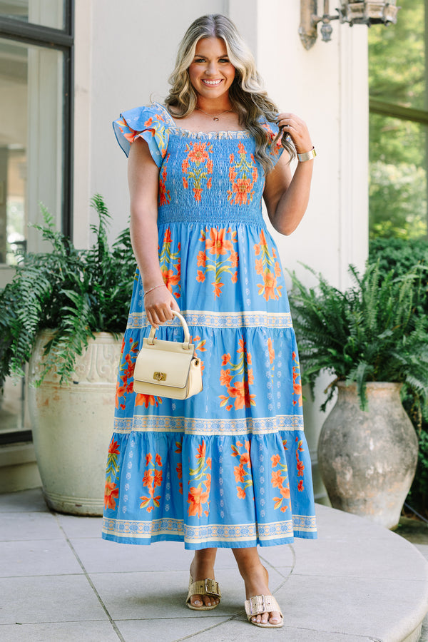 Plus Size blue tiered maxi dress with orange floral print, smocked bodice, and flutter sleeves.