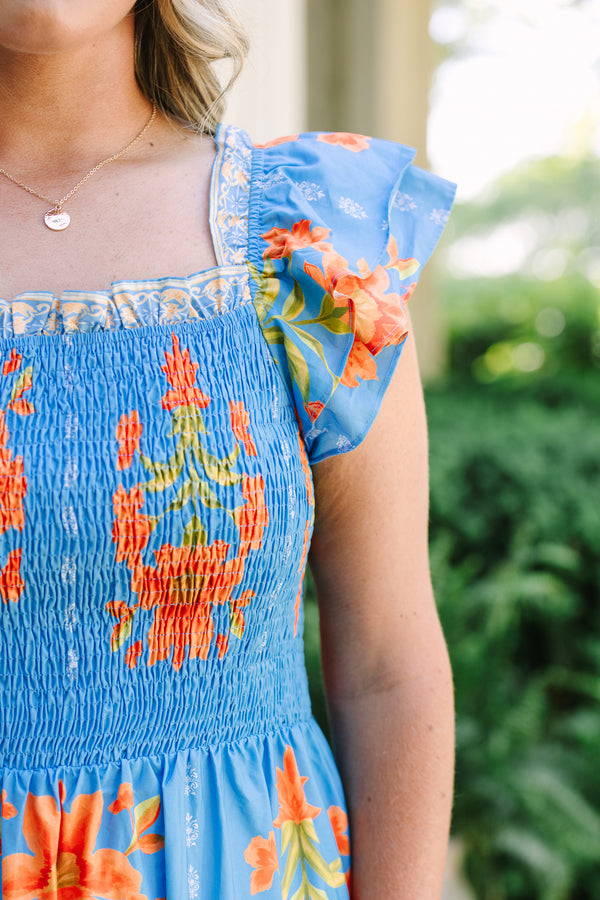 Plus Size blue tiered maxi dress with orange floral print, smocked bodice, and flutter sleeves.