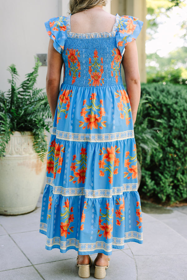 Plus Size blue tiered maxi dress with orange floral print, smocked bodice, and flutter sleeves.