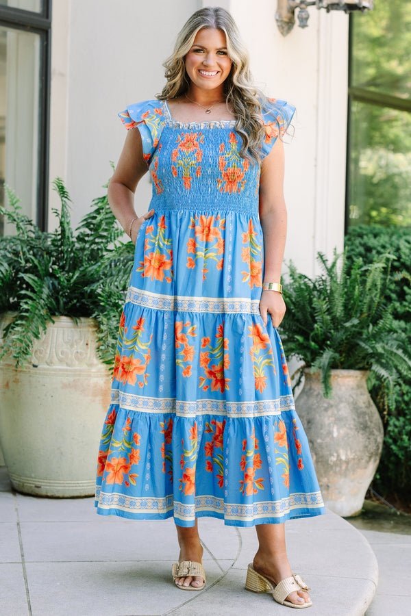 Plus Size blue tiered maxi dress with orange floral print, smocked bodice, and flutter sleeves.