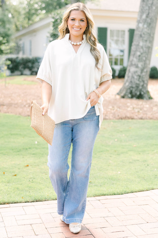 Plus Size beige short sleeve top with a V-neckline and elasticized puff sleeves.