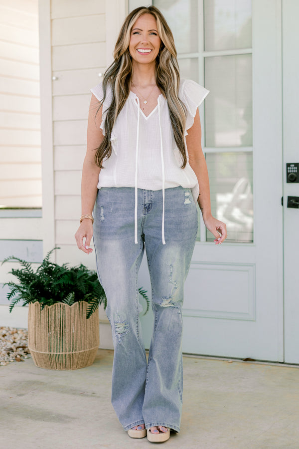 Chic Soul plus size clothing, light-wash flare jeans with a distressed look and holes in the knees