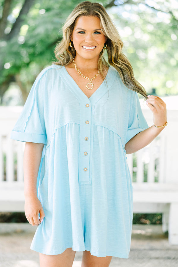 Plus Size aqua romper with a V-neckline, functional front buttons, short sleeves, and side pockets.