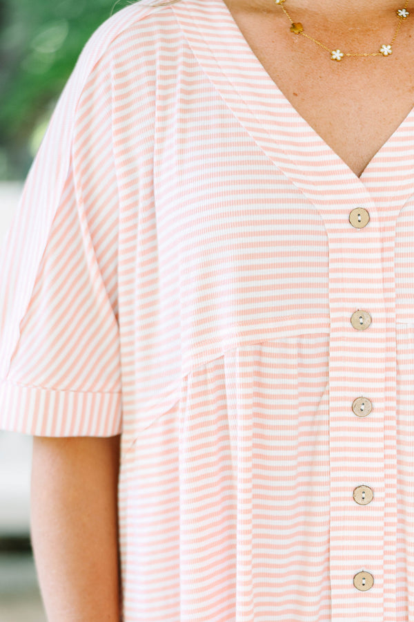 Plus size pink and white striped romper with a flowy fit, V-neck, and functional front buttons.