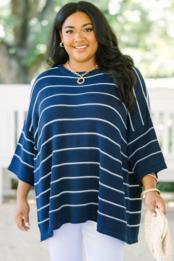 Plus Size navy and white horizontal striped knit sweater tunic with a relaxed fit and wide sleeves.