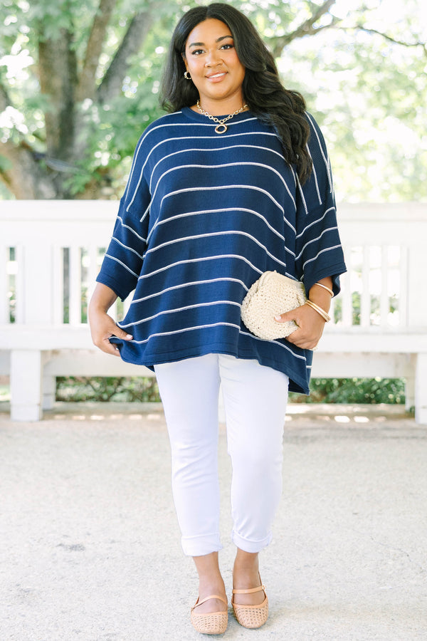 Plus Size navy and white horizontal striped knit sweater tunic with a relaxed fit and wide sleeves.