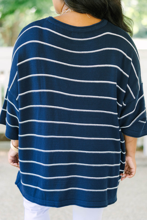 Plus Size navy and white horizontal striped knit sweater tunic with a relaxed fit and wide sleeves.